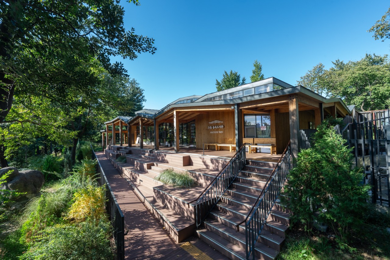 숲과 어우러진 도서관의 평화로운 전경