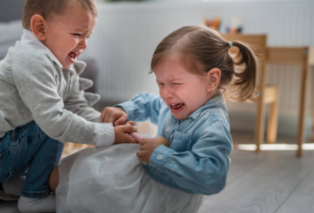 preschool kids fighting over toy