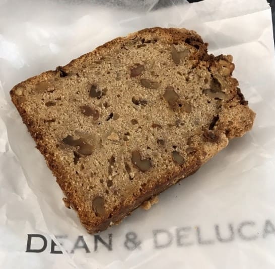 갈색의 빵이 흰색 포장지 위에 있다.