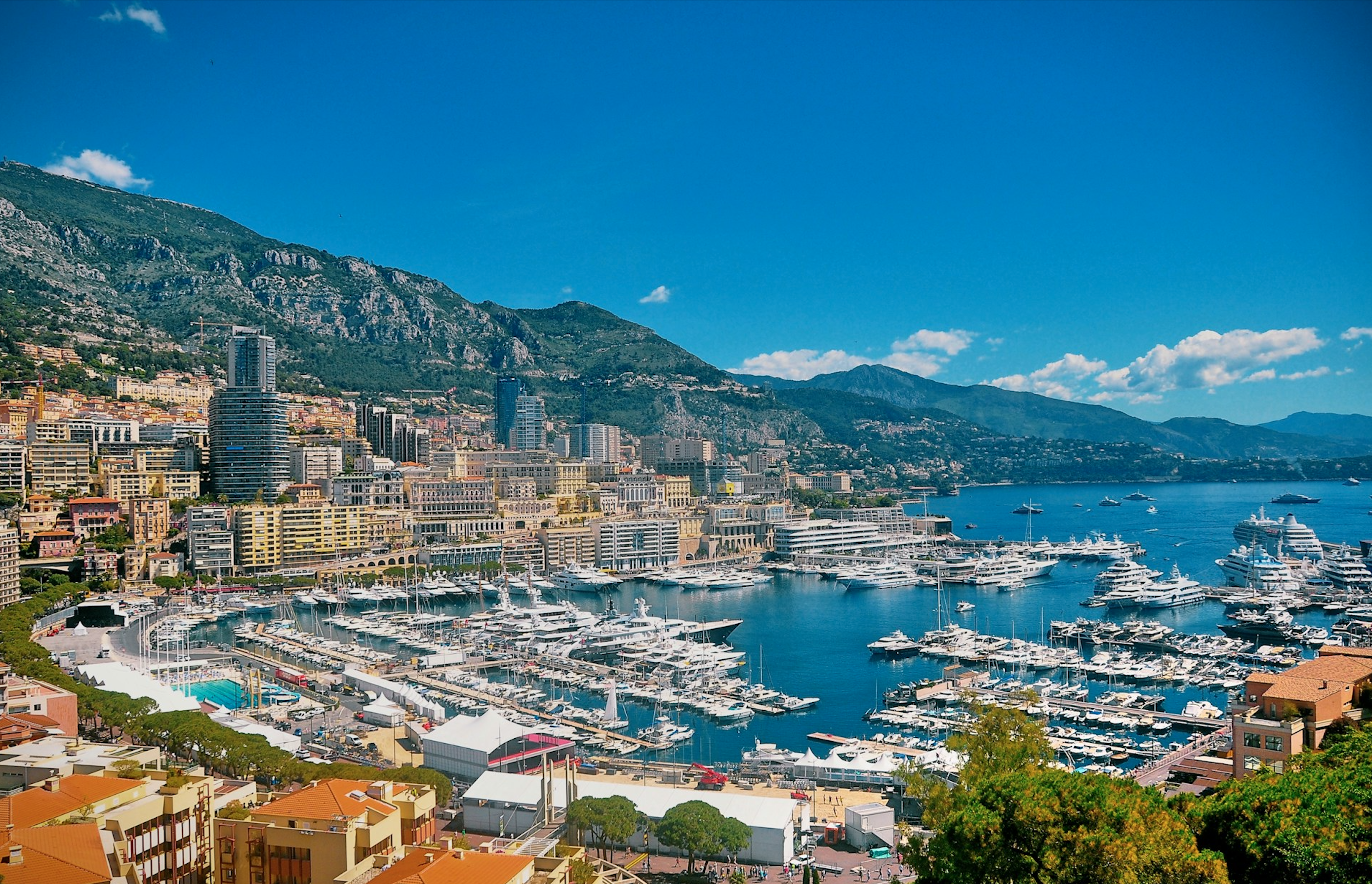 A vibrant high-angle view of Monte Carlo harbor, filled with luxury yachts