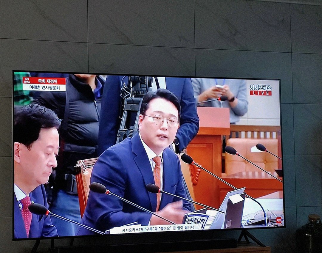 Korean Asian man in 40s looking tired at outdoor business meeting