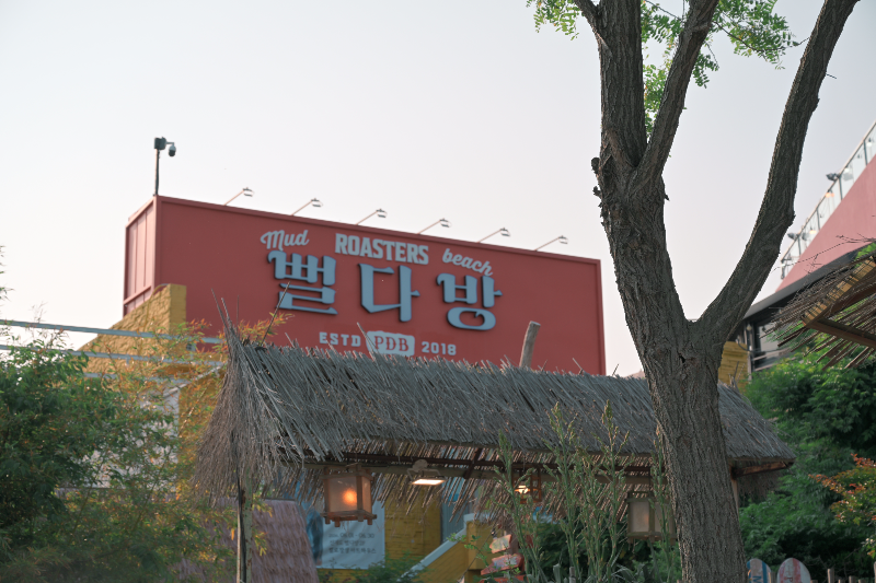 멀리서도 볼수 있는 주황색 바탕의 파란 글자의 뻘다방 간판