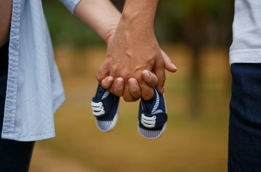임산부 부부가 손 맞잡은 사진
