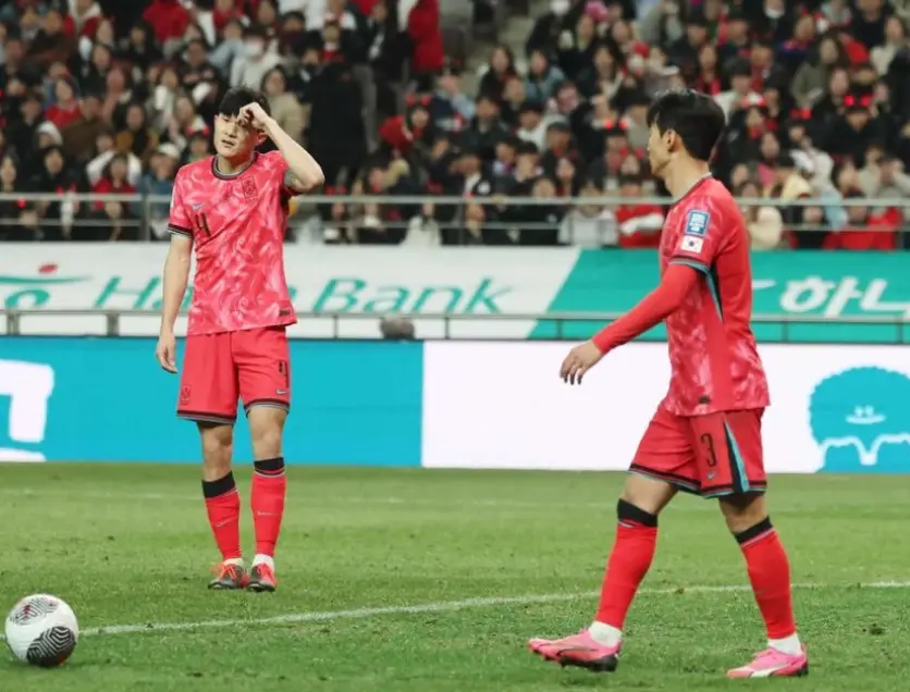 태국전- 붉은 국가대표 유니폼을 입은 선수 두명이 아쉬워 하며 축구장에서 걷고있는 모습