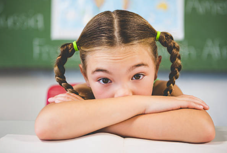 elementary student suppressing emotion