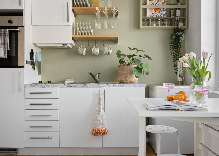 kitchen with white cabinets and flowers