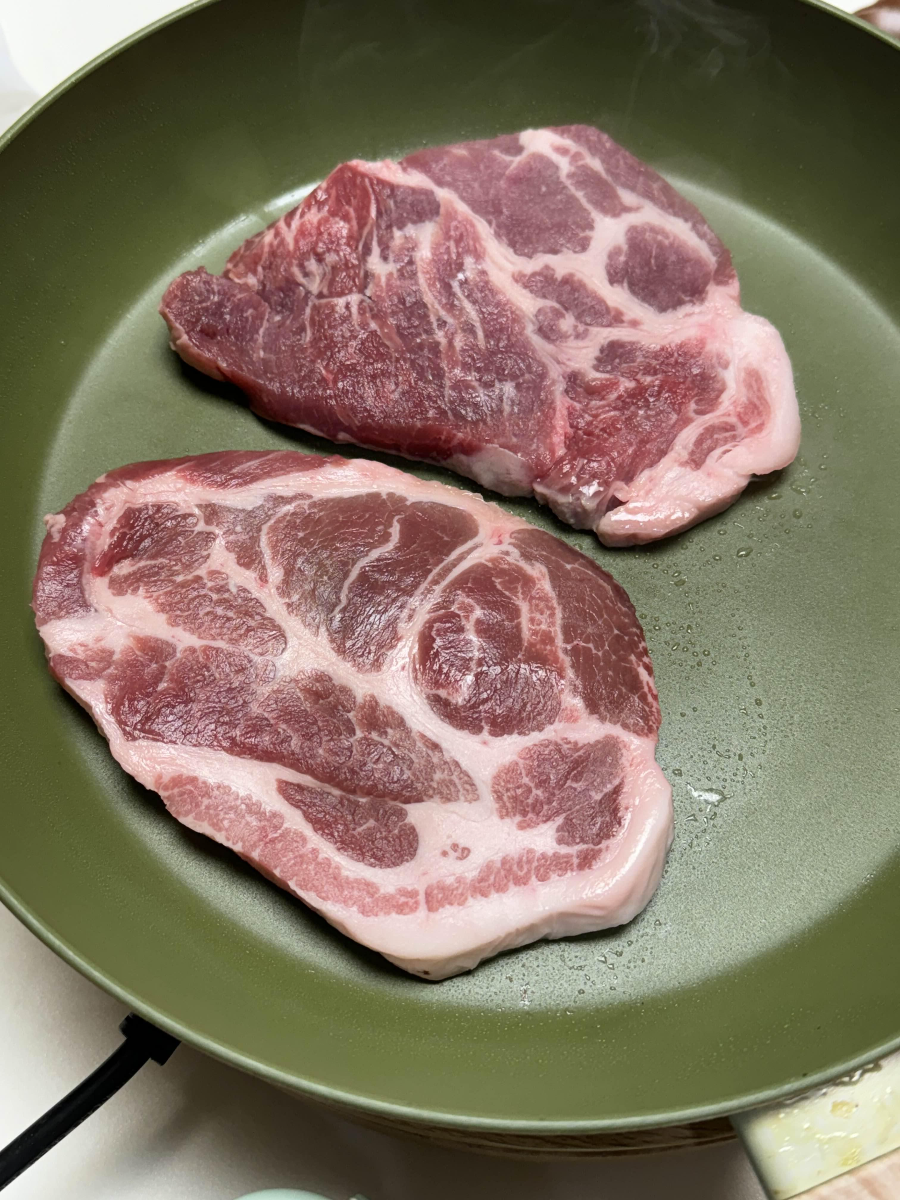 흑돼지 목살을 후라이팬에 굽고 있다