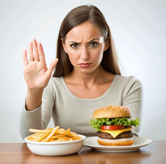 행버거와 감자튀김을 앞에 두고 먹으면 안된다고 손으로 표시하는 여성