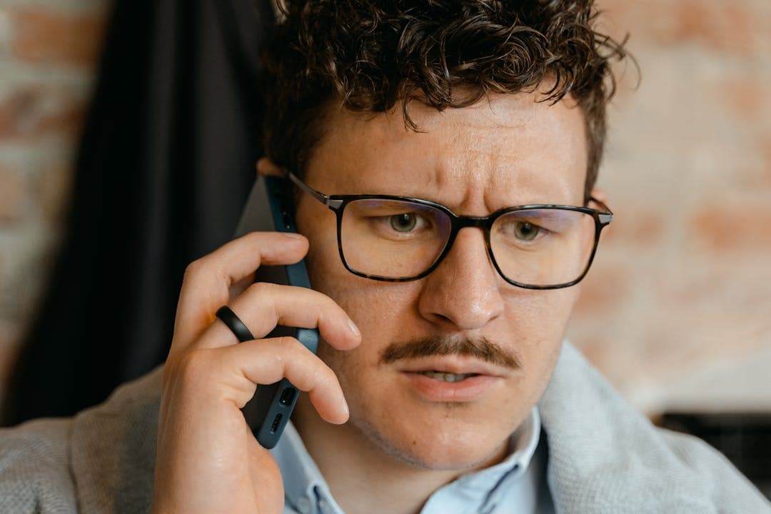 의심스러운 전화를 받고 당황하는 남성