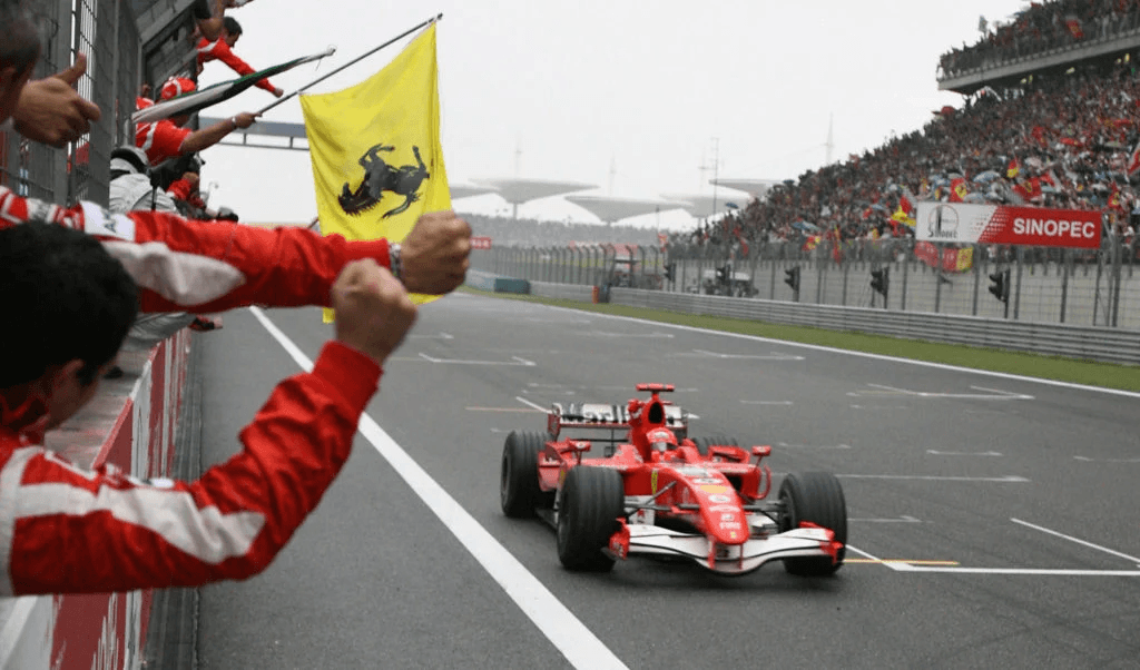 Ferrari Formula One driver Michael Schumacher of Germany crosses the finish line on his way to winning the China Grand Prix at the Shanghai International Circuit, 01 Oct 2006. (CLARO CORTES IV / POOL / AFP)
