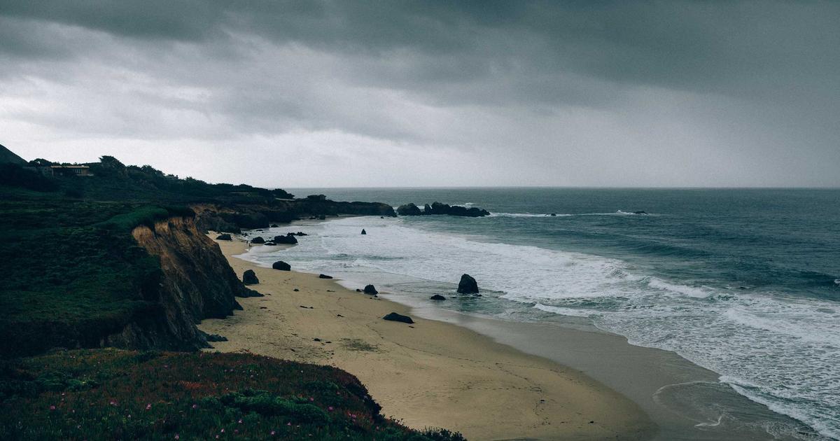 person happily refilling groceries at zero waste store