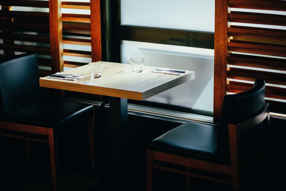 A stylish dining setup with a wooden table and chairs, perfect for a cozy meal.