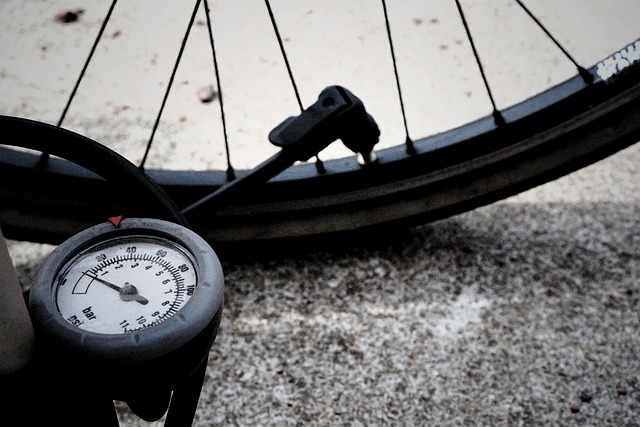 pumping air into the bike wheel.