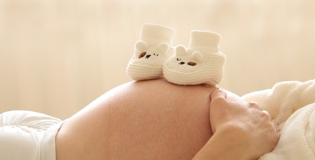 임신한 엄마 배 위의 아기 신발