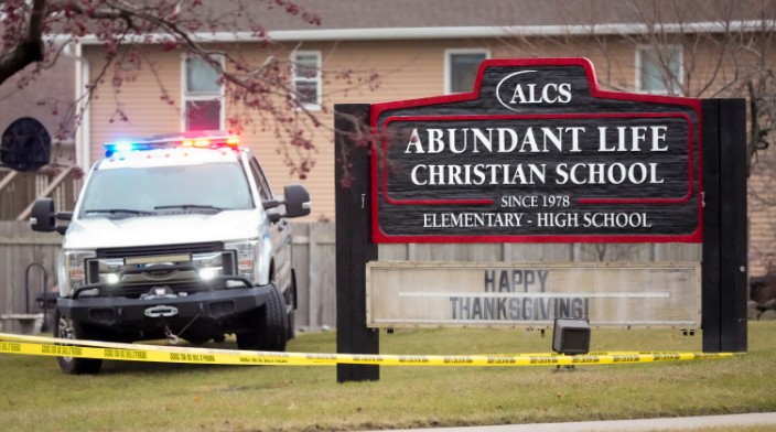 Emergency vehicles are parked outside the Abundant Life Christian School in Madison, Wis., following a shooting, Monday, Dec. 16, 2024.