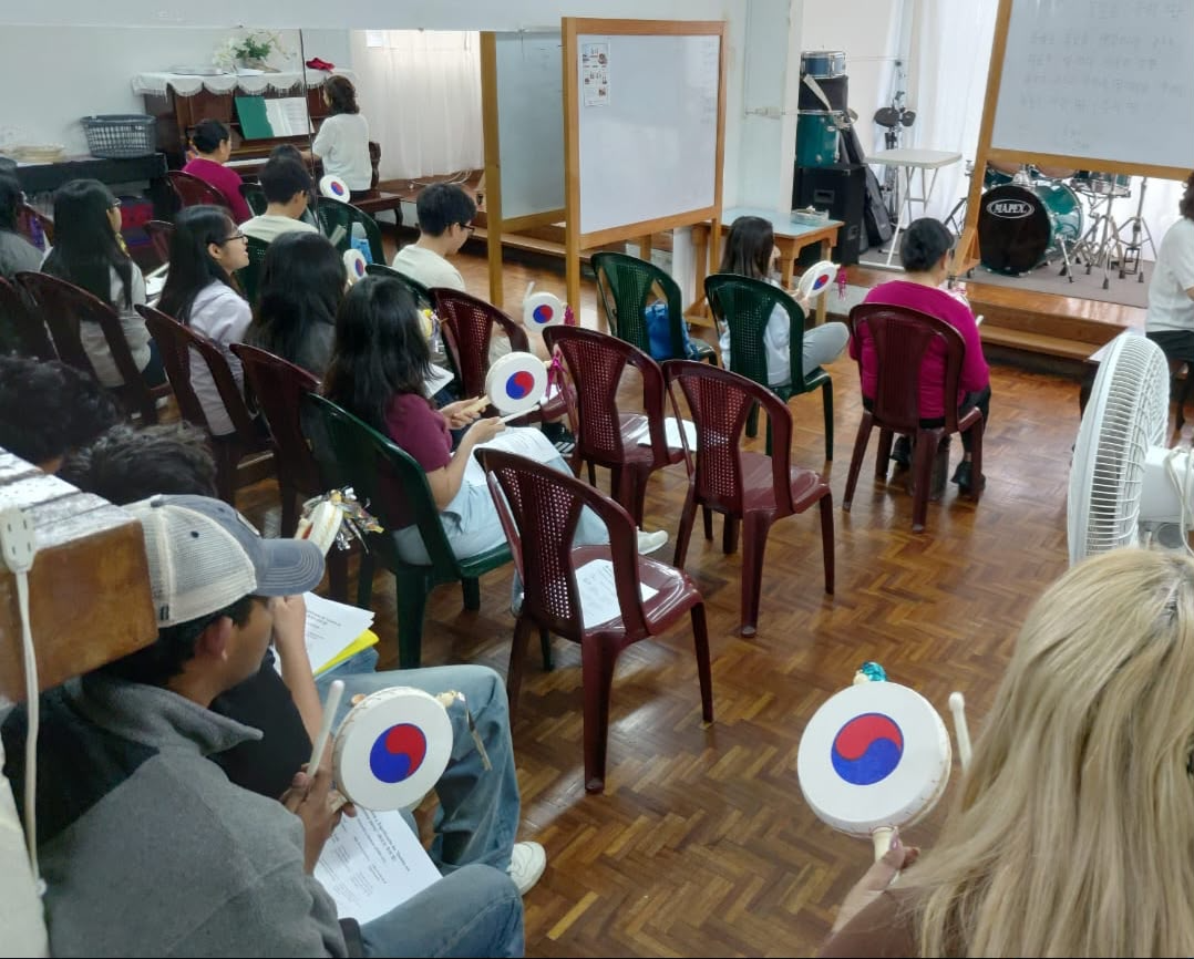 과테말라에서 진행된 한국어 수업에서 학생들이 태극 문양의 소고를 들고 아리랑을 배우는 모습.