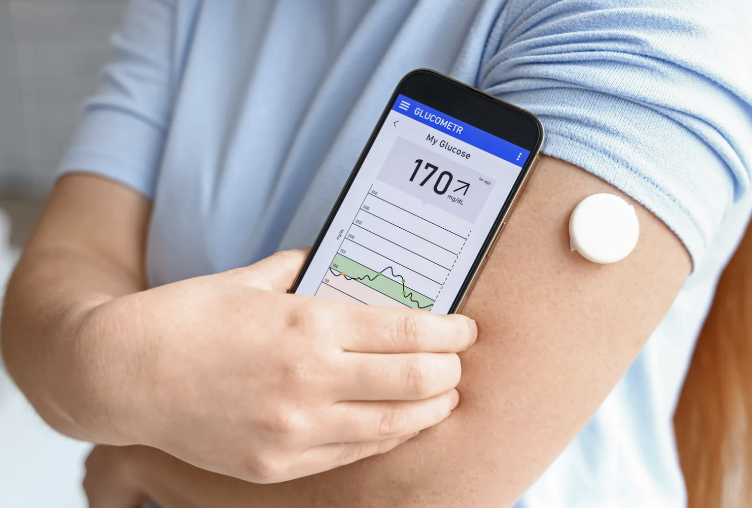 man checking his glucose with his cell phone