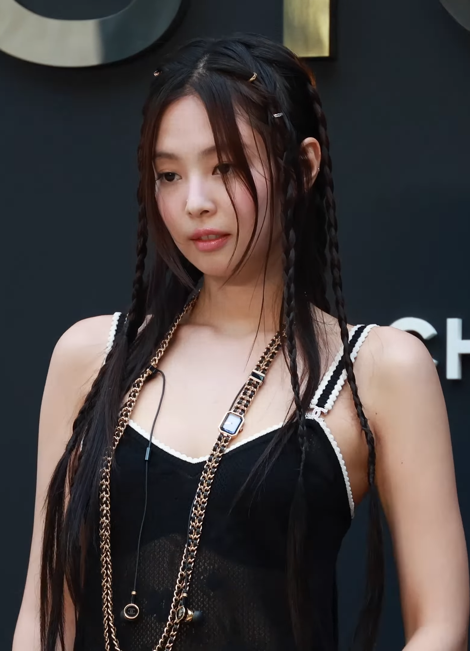 Jennie at the July 2024 Chanel Coco Crush event, with braided hair, soft eye makeup and rose lips.