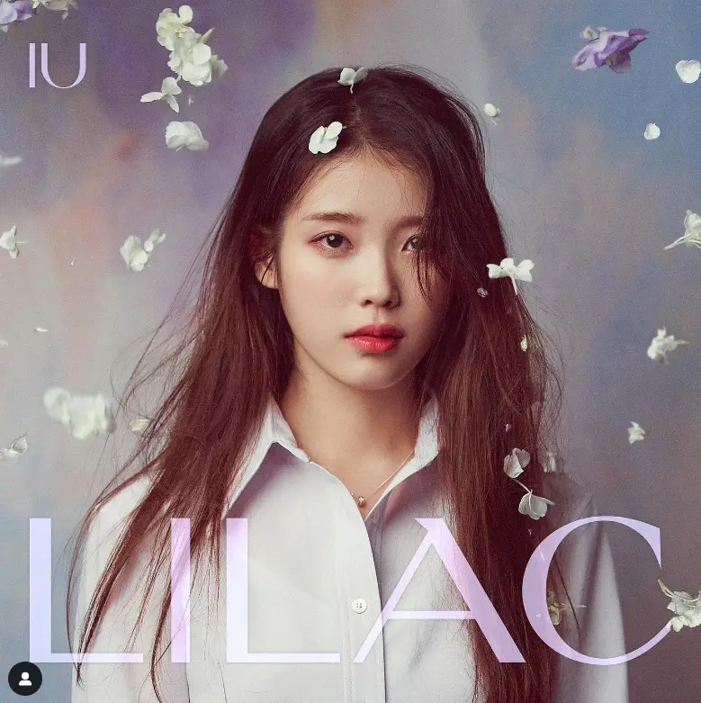 싱어게인 3- 라일락 꽃잎이 떨어지는 배경 앞 흰셔츠에 머리를 길게 늘어뜨린 무표정한 아이유 사진 하단 lilac 글이 적힌 앨범 표지