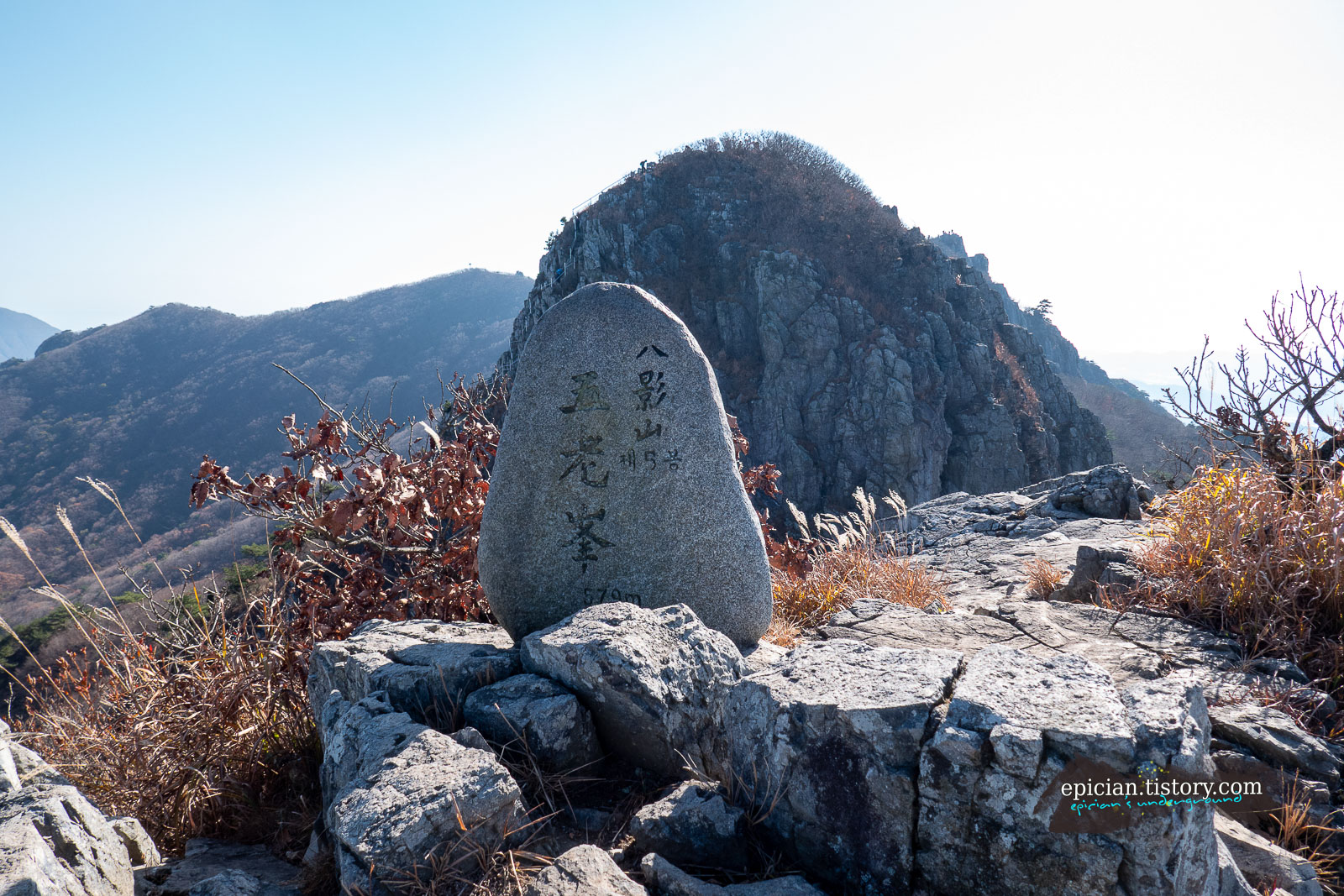 둥근 오로봉 정상석과 그 뒤편으로 보이는 두류봉