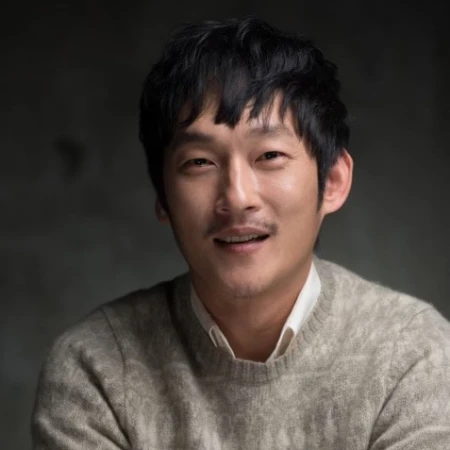 갈색 티셔츠에 검은 머리와 콧수염이 난 오늘도 사랑스럽개의 오상수 캐릭터