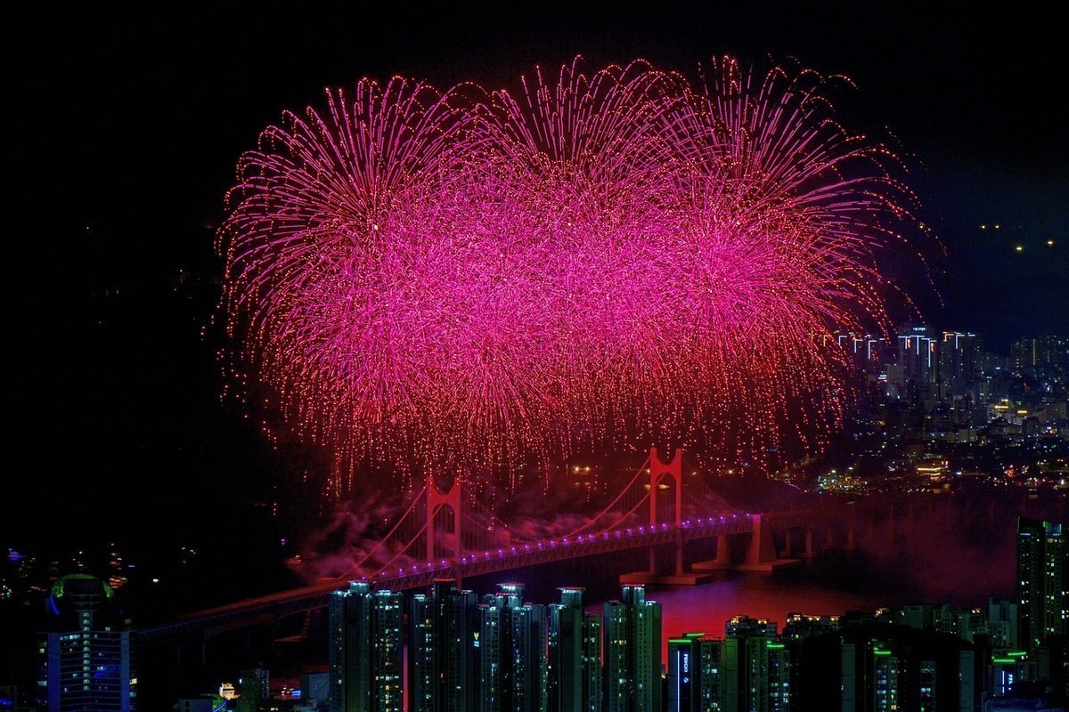 Fireworks bursting over Gwangan Bridge above Gwangalli Beach in Busan at night