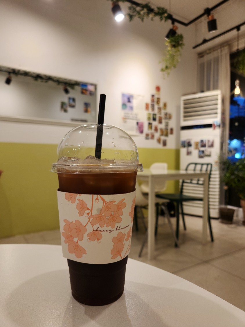 테이블 위에 이벤트 참여로 받은 아메리카노 한 잔이 올려져 있다.