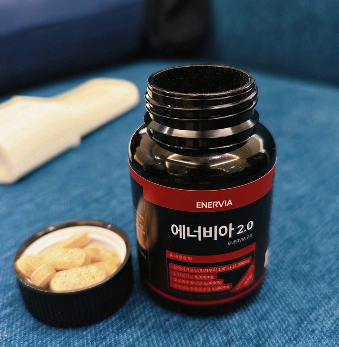Korean Asian man taking supplement after dinner at home
