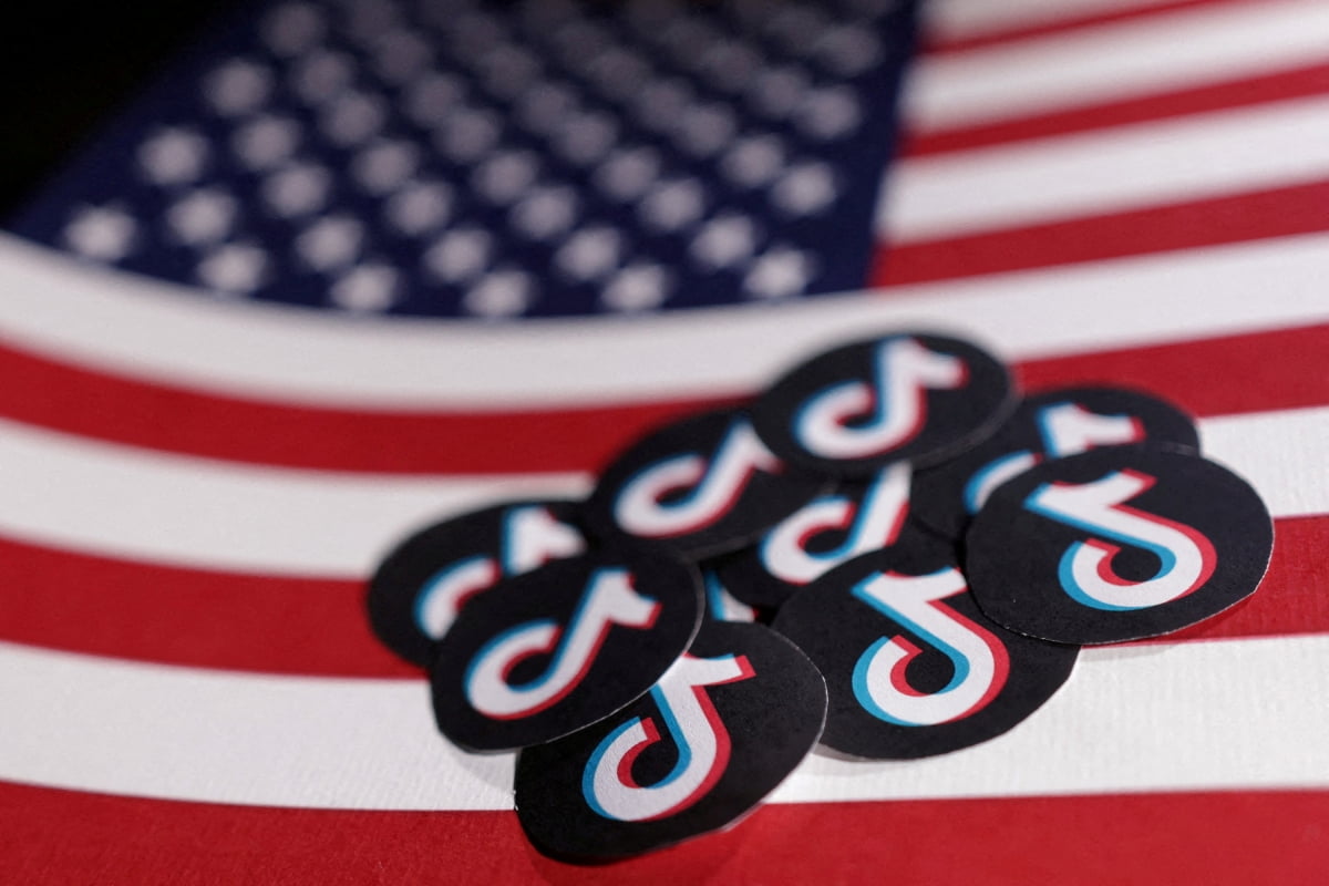 U.S. flag and TikTok logos are seen in this illustration taken