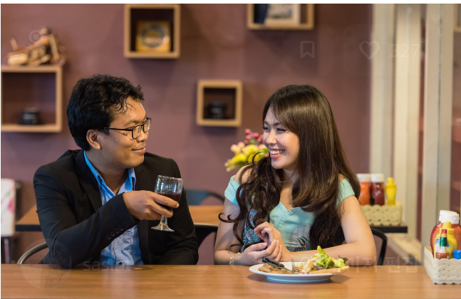 레스토랑에서 함께 식사하며 즐겁게 대화하는 두 사람, 서로의 이야기에 집중하며 미소 짓는 모습