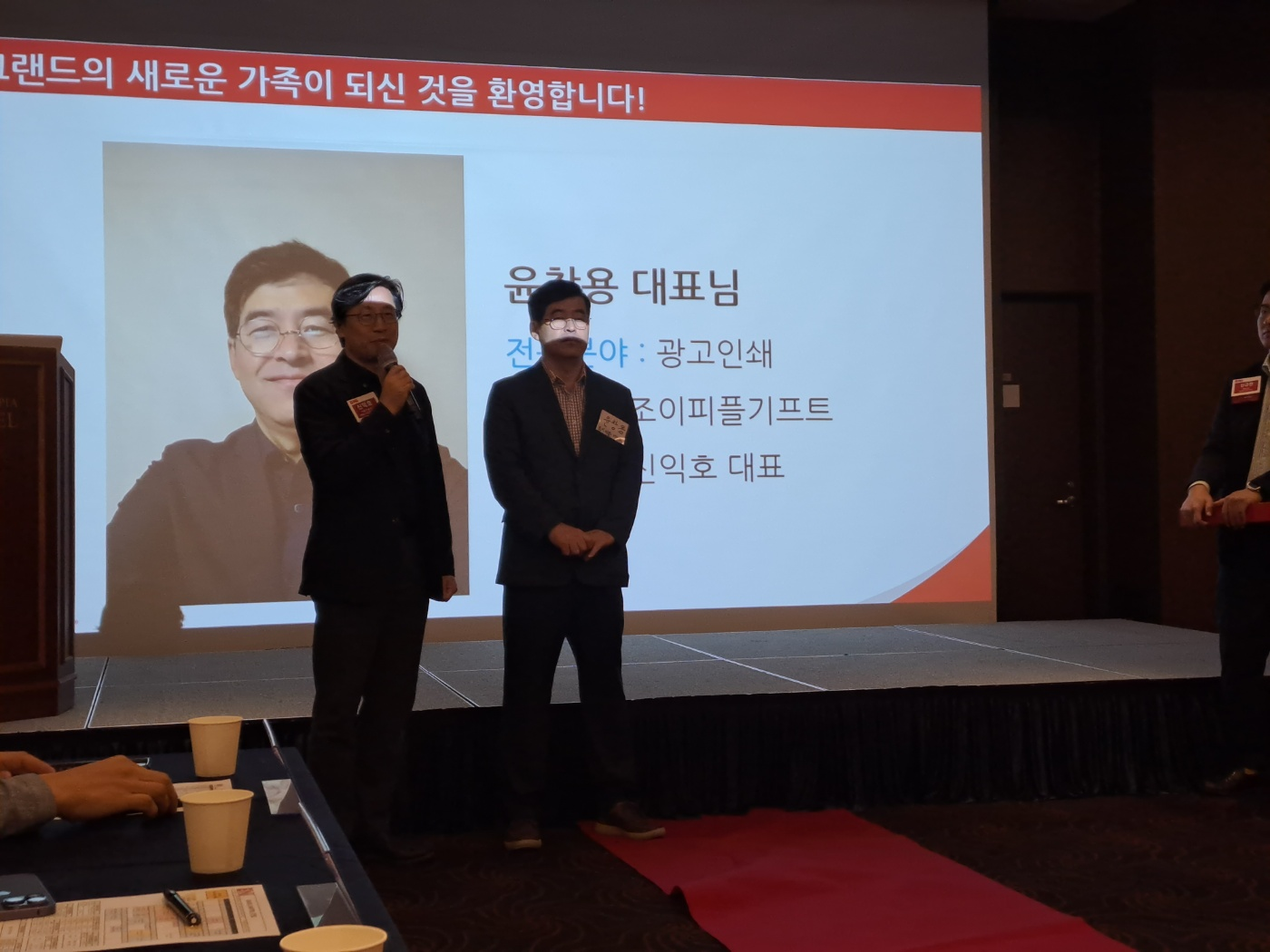 비엔아이그랜드챕터의 38번째 멤버가 되신 조이피플기프트 윤창용대표님의 가디언이신 우리안 신익호 대표님께서 윤창용대표님을 주간회의 연단에서 소개하고 있는 모습입니다.