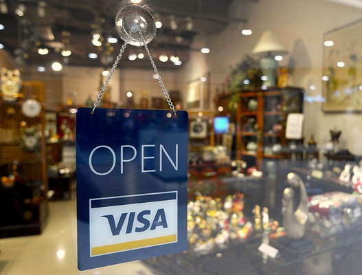 Shops with an open signboard with a Visa card mark
