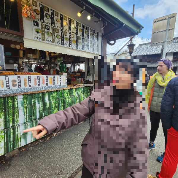각종 간식들을 파는 가게 앞을 지나는 아내가 먹고 싶은 것을 가르키고 있다.