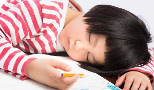 책상에 엎드려 자는 아이