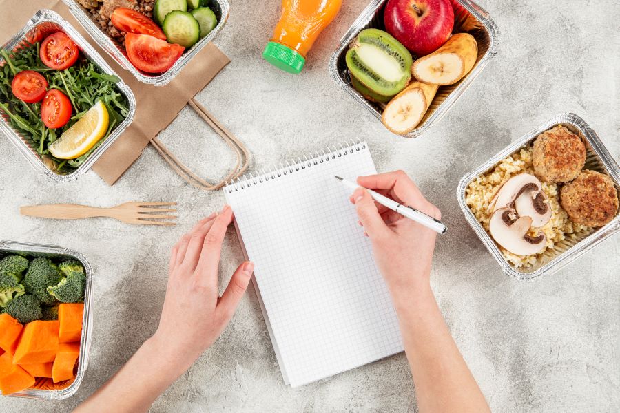 flat-lay-casseroles-with-meals-hand-writing-notebook-900