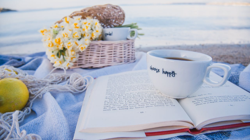 Coffee mug on top of open book solo picnic