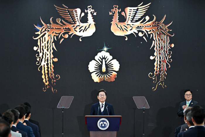 대통령을 상징하는 봉황 앞에 서있는 이재명의 모습