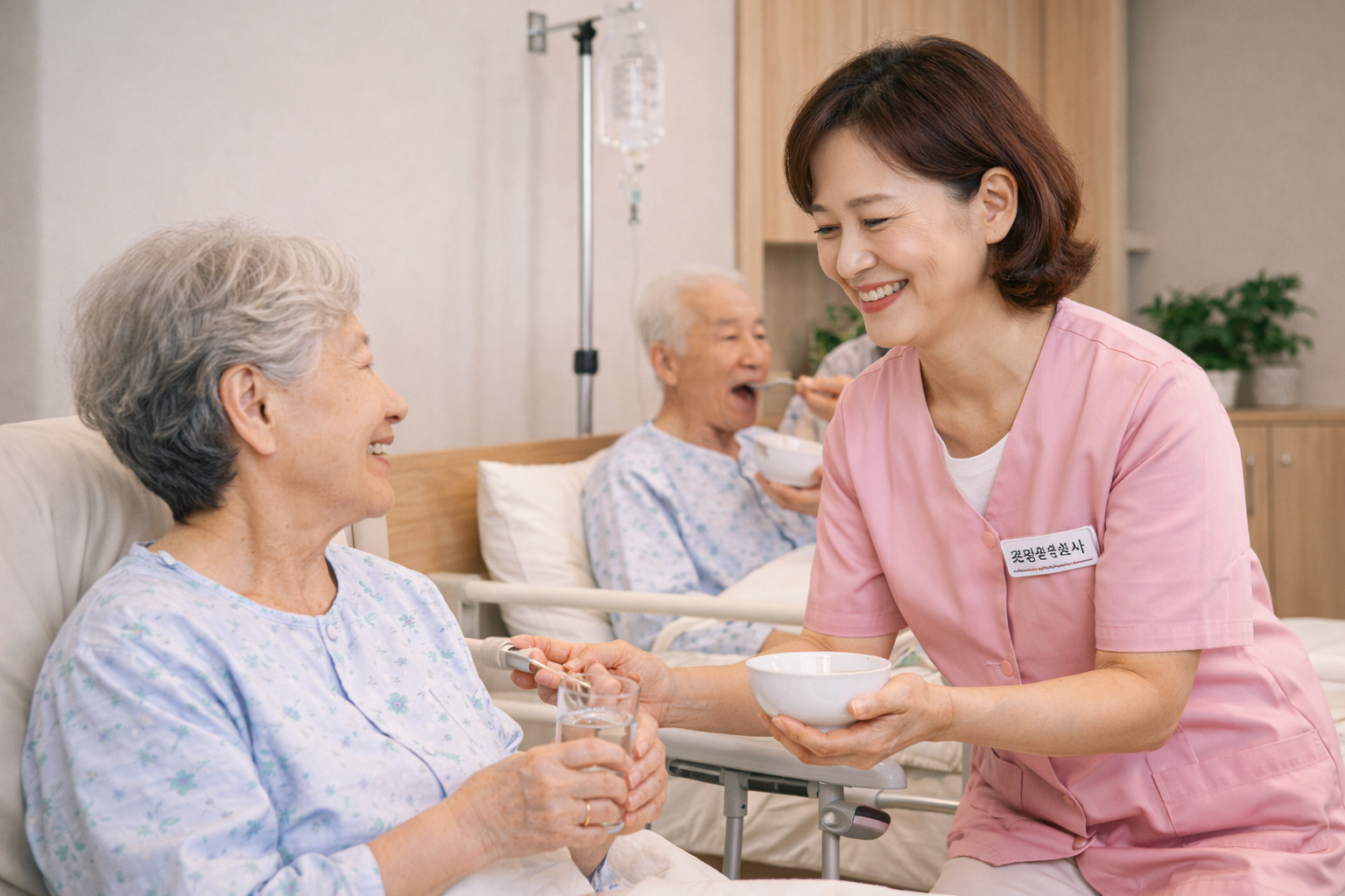 요양병원에서 요양보호사가 어르신 환자를 돌보며 식사와 수분 섭취를 도와주는 모습
