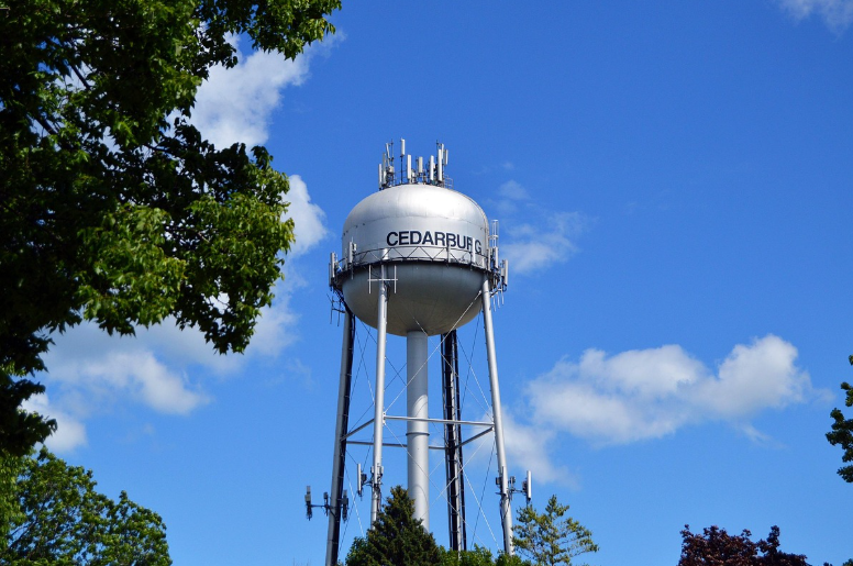Metal water tower under blue sky
