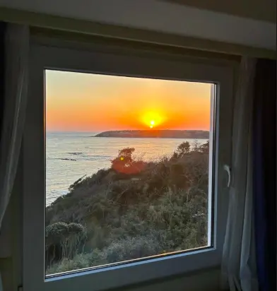 hotel room with ocean view through a window