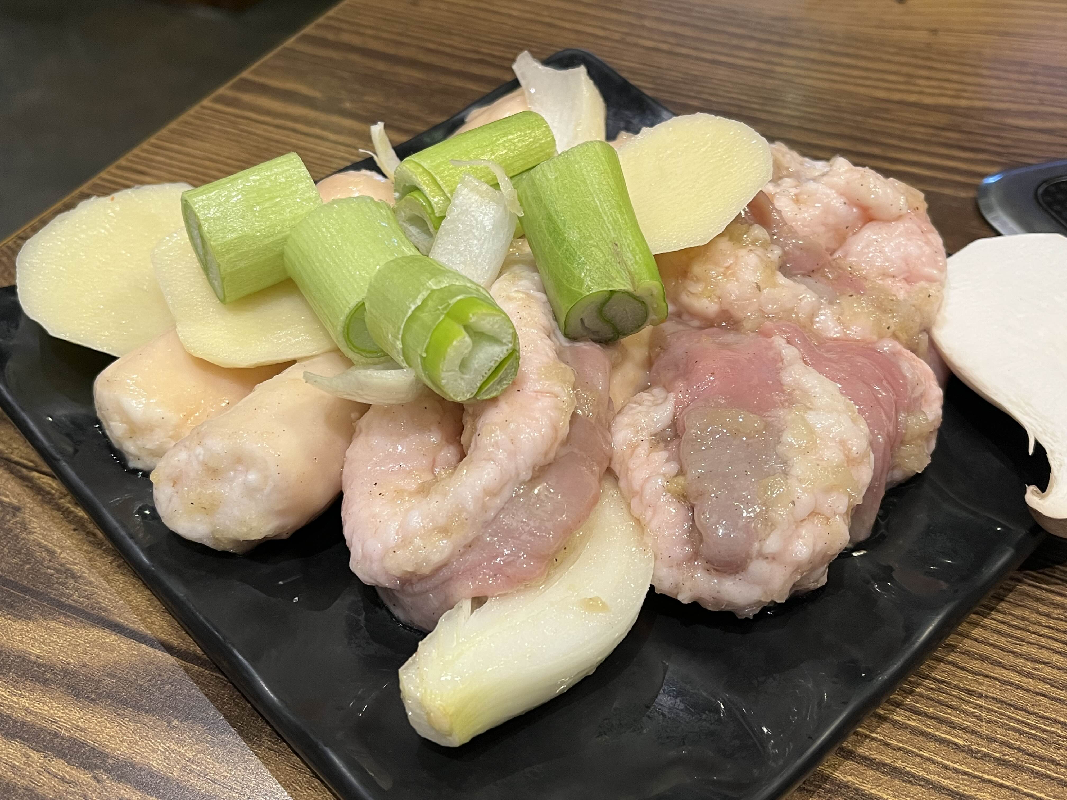 곱창&#44; 대창&#44; 파&#44; 감자&#44; 버섯&#44; 양파가 한 접시에 담겨있는 사진