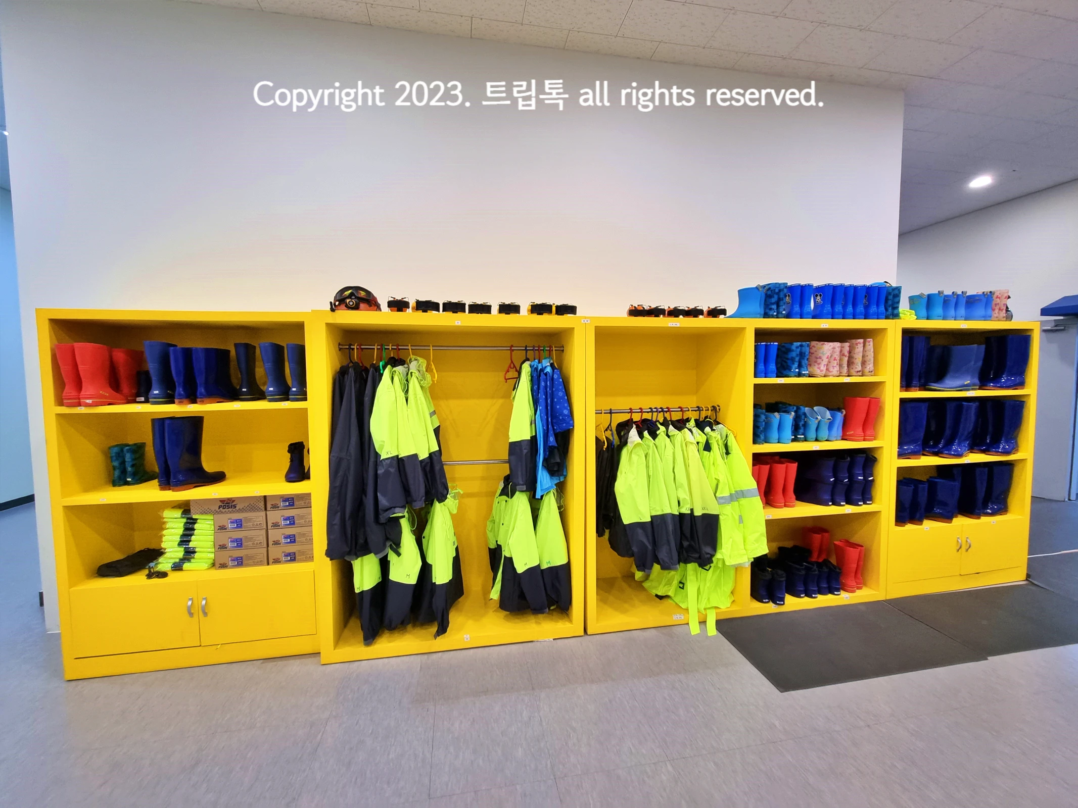 노란색 옷장에 장화와 체험복들이 정리되어있다.