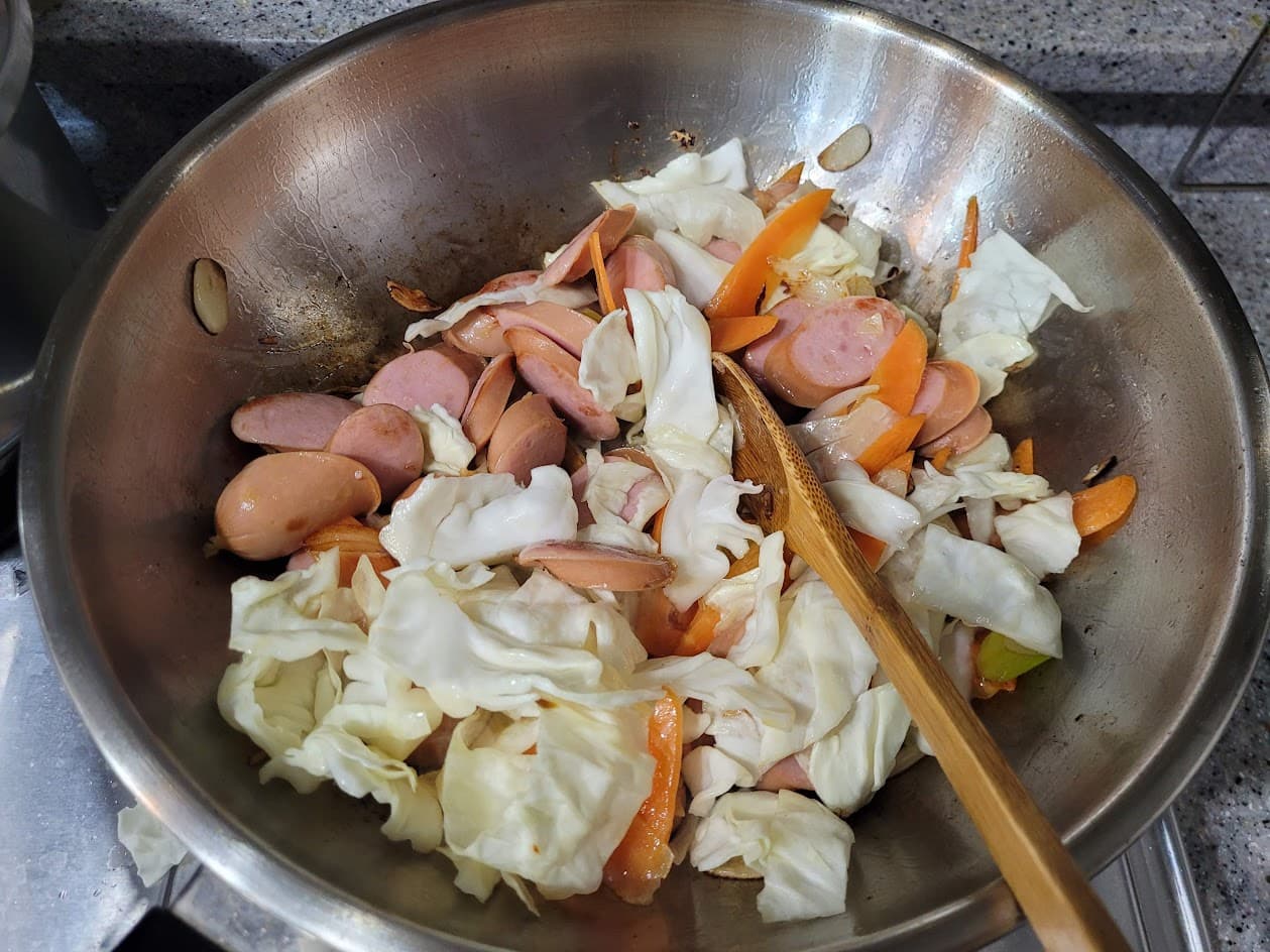당근과 양배추를 순서대로 넣어 볶는 모습