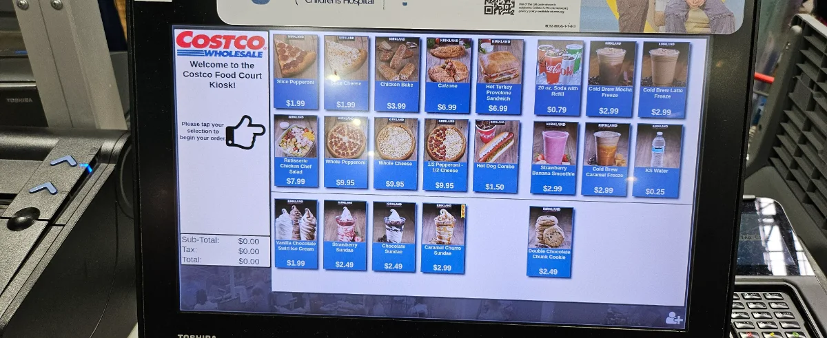Costco food court self-order kiosk screen displaying full menu with prices