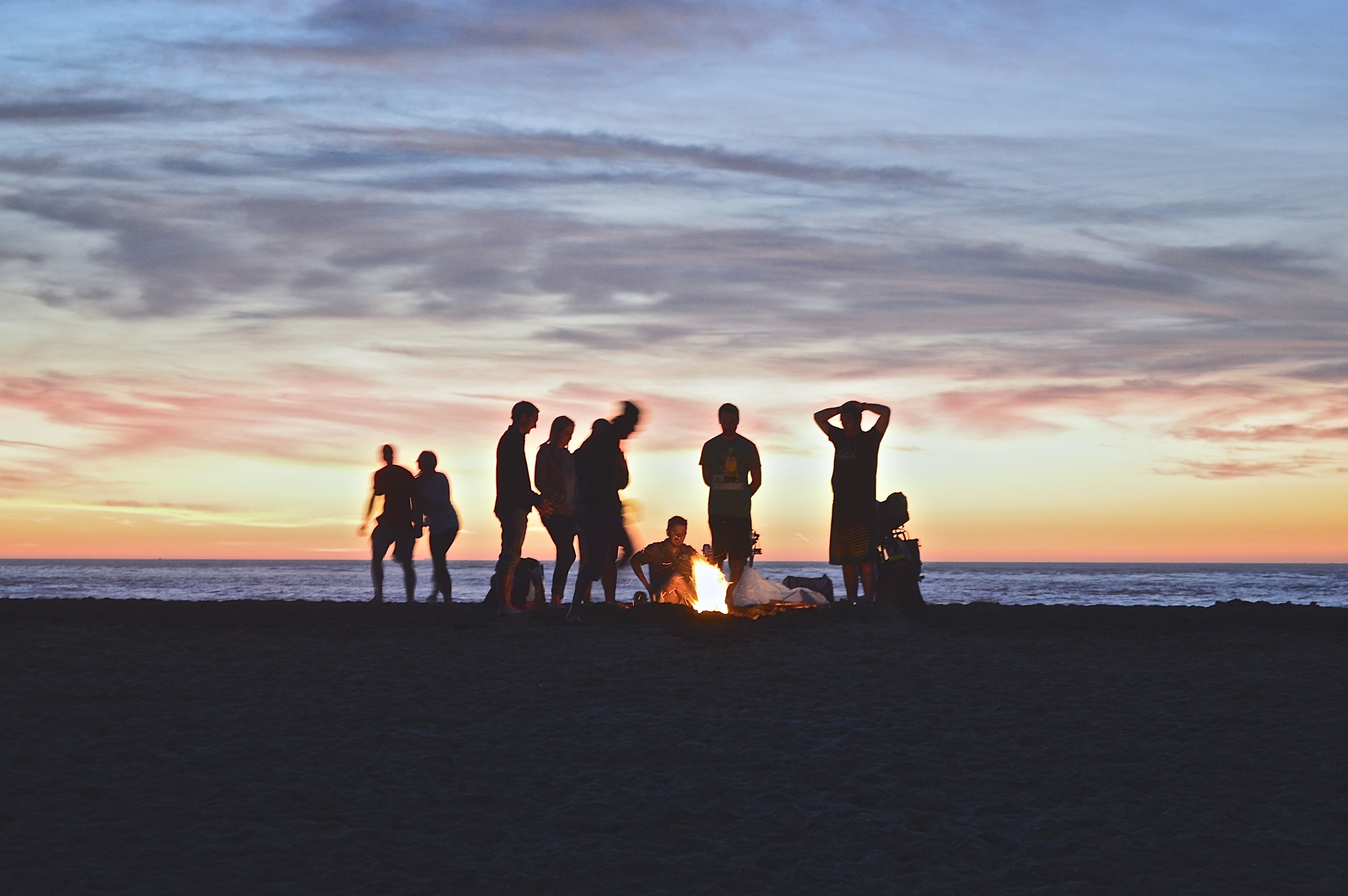 A group gathered in front of a bonfire