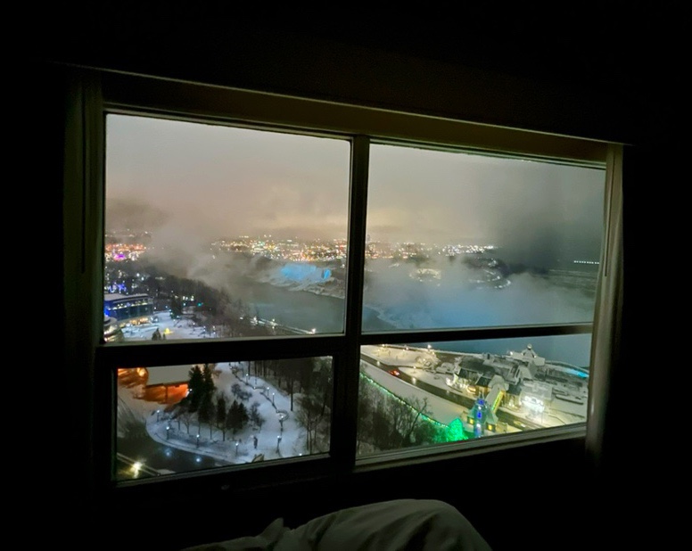 Niagara Falls view from the bed inside Embassy Suites Niagara Falls room