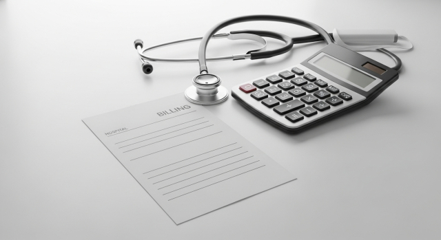 청구서와 계산기&amp;#44; 청진기를 배치해 검사 비용을 상징적으로 표현한 이미지