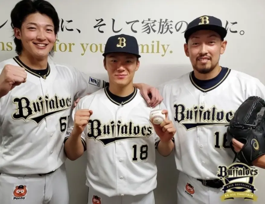 흰유니폼을 입고 동료들과 기념촬영을 하는 야마모토