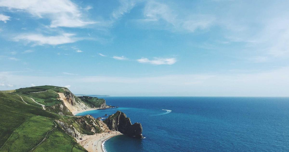 Tired office worker looking at a variety of supplements on a desk with a cup of coffee