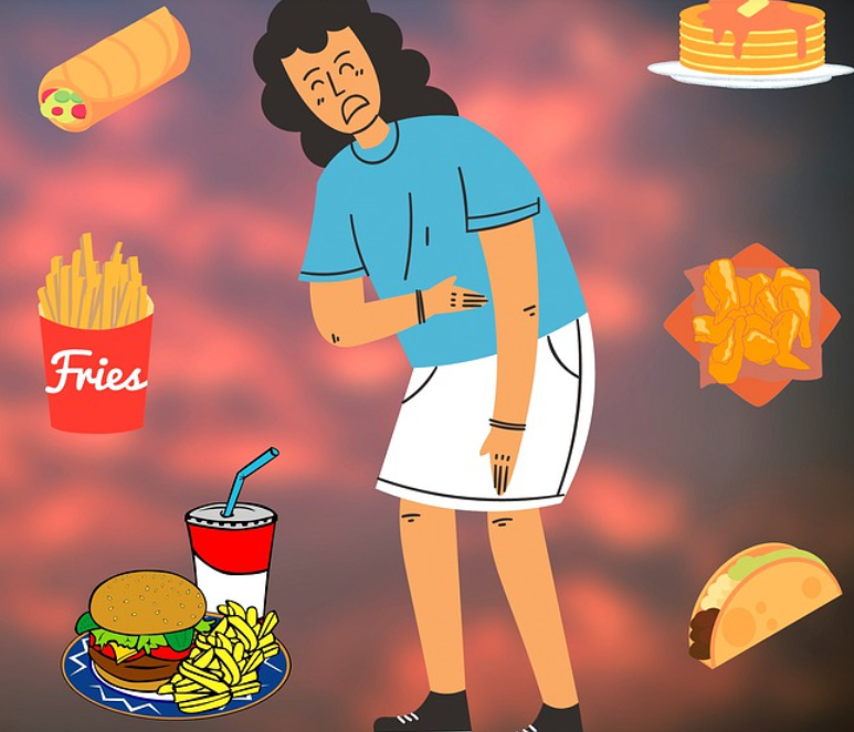 햄버거, 감자튀김 등을 먹고 복통을 호소하는 여성